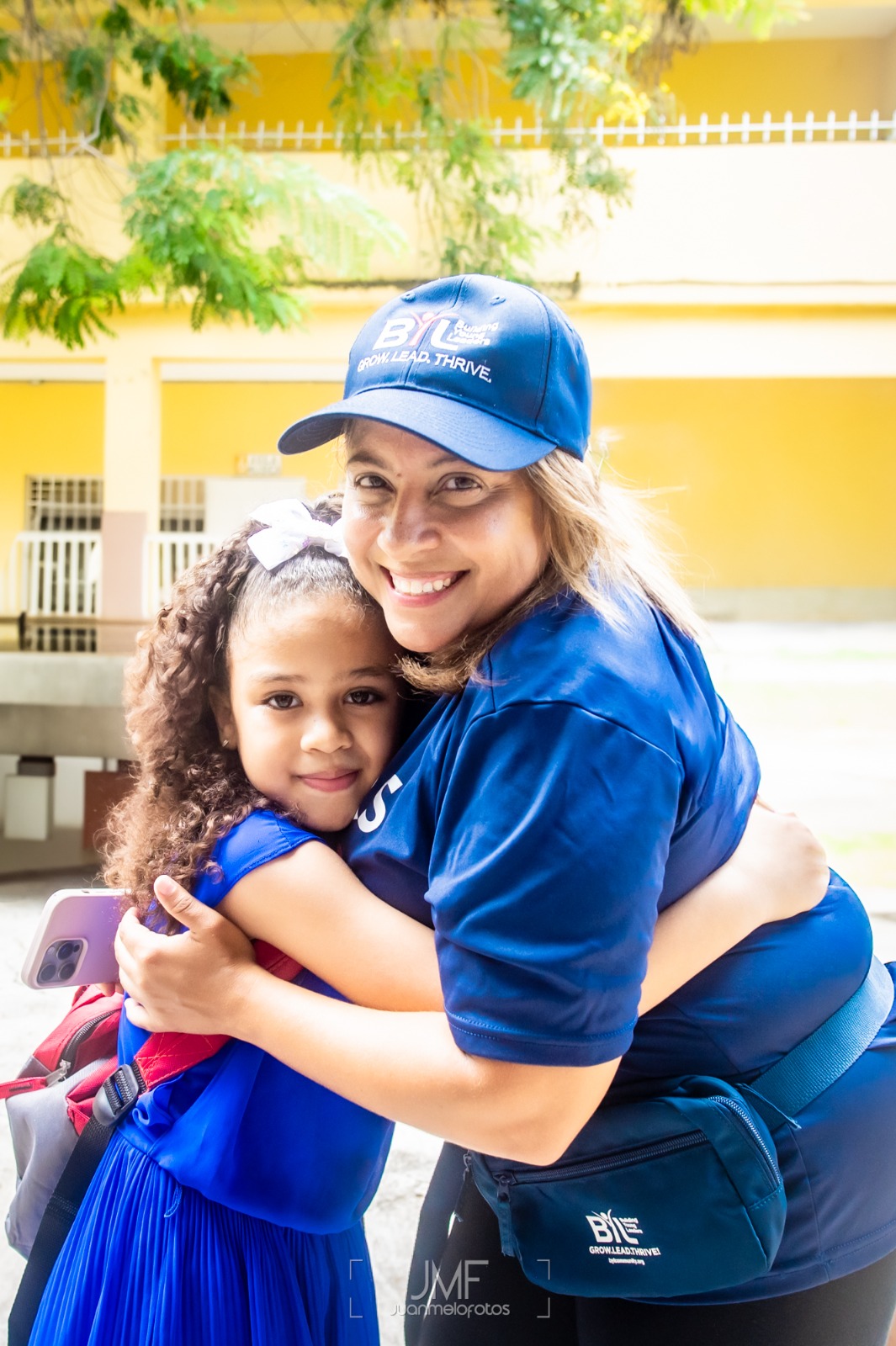 Students receiving school supplies from BYL volunteers
