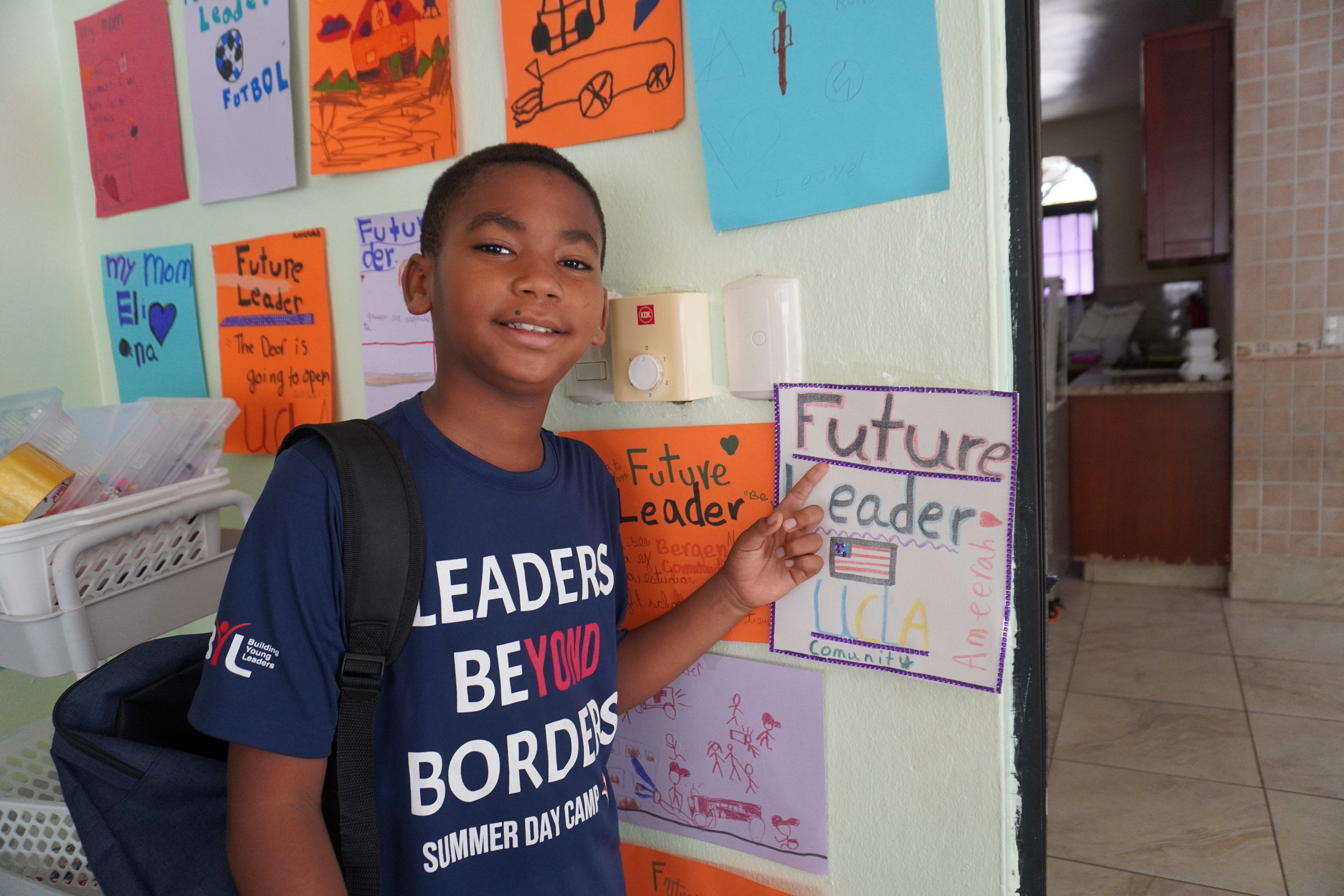 BYL student pointing at a Future Leader drawing during a Leaders Beyond Borders Summer Day Camp activity